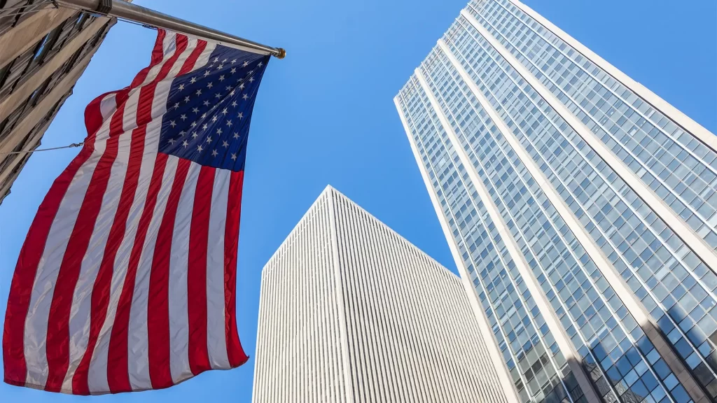 American flag in front of a high-rise building